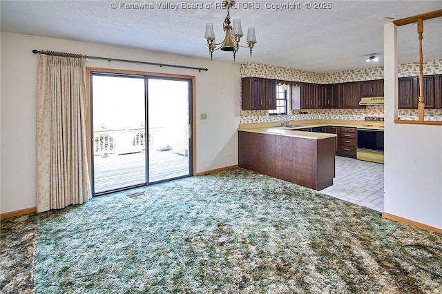 kitchen featuring range with electric cooktop, a textured ceiling, light colored carpet, dark brown cabinets, and a chandelier