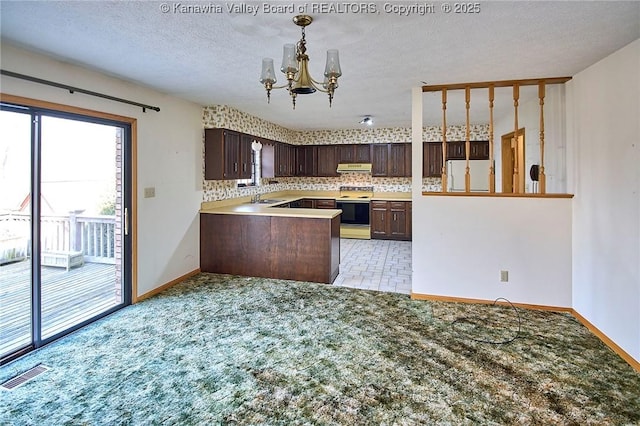 kitchen featuring visible vents, electric stove, a sink, white refrigerator, and dark brown cabinets