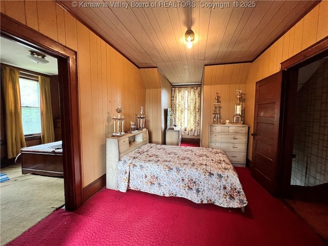 bedroom with wood ceiling, carpet, and wood walls