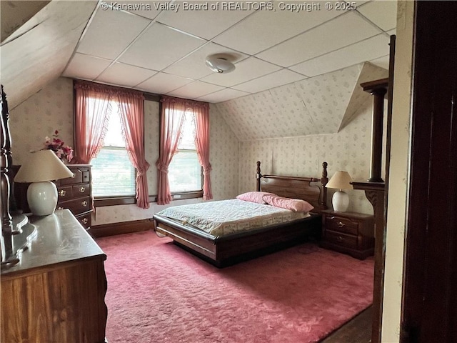 carpeted bedroom with wallpapered walls, vaulted ceiling, and baseboards