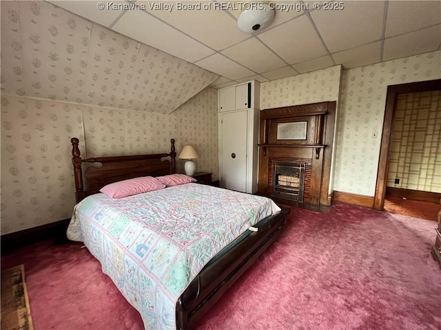 bedroom featuring a drop ceiling, wallpapered walls, baseboards, and carpet floors