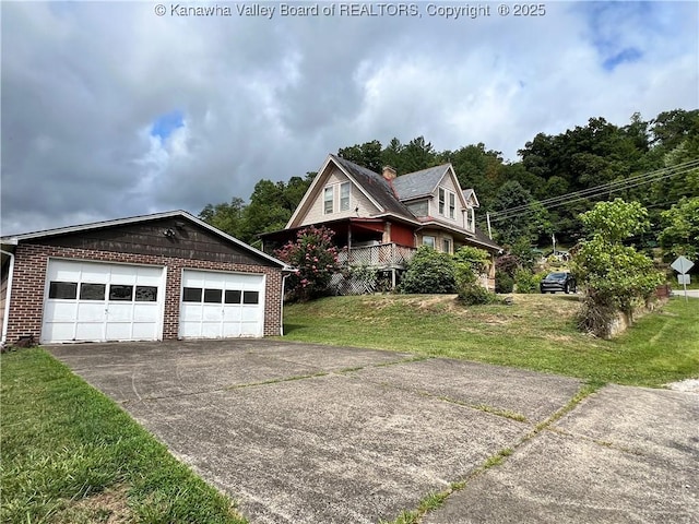 view of front of home featuring a garage, brick siding, and a front yard