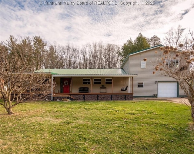 view of front of house featuring a front yard, covered porch, concrete driveway, a garage, and metal roof