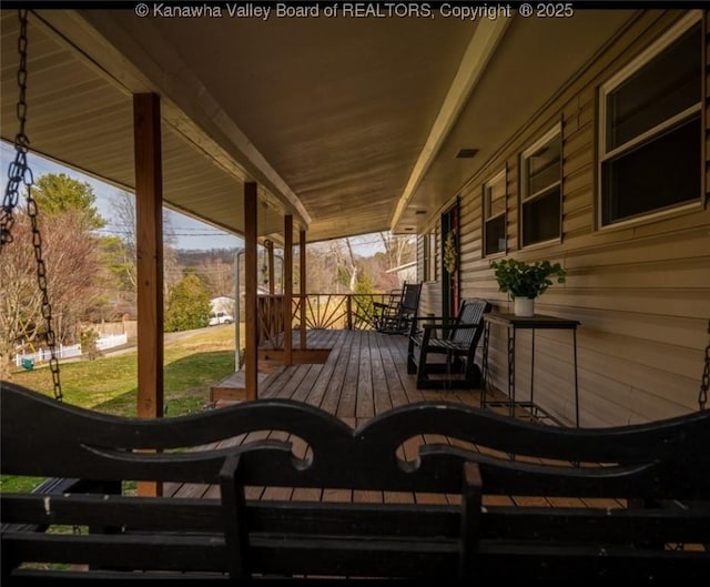 wooden terrace with a porch