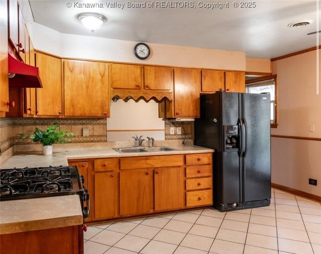 kitchen with visible vents, black appliances, light countertops, and a sink