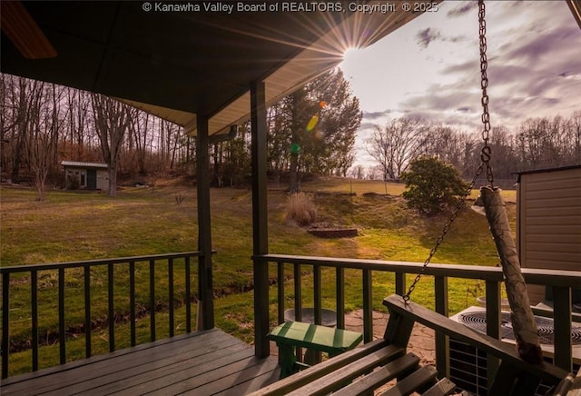 wooden deck featuring a yard