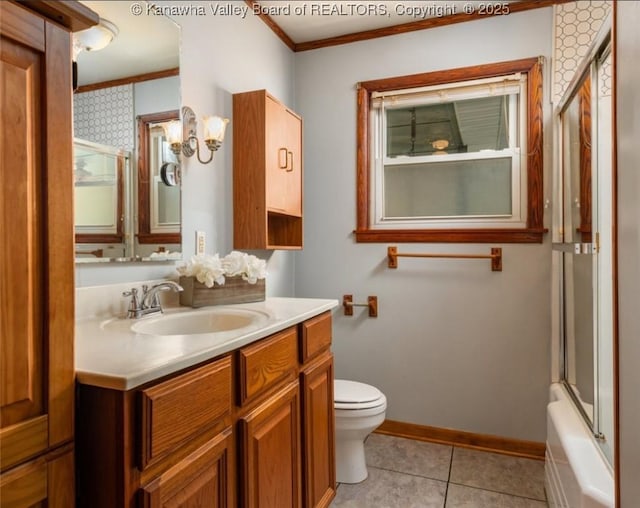 bathroom with crown molding, baseboards, toilet, tile patterned floors, and vanity