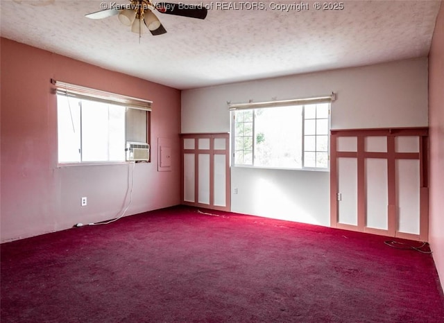 carpeted spare room featuring a textured ceiling, cooling unit, and ceiling fan