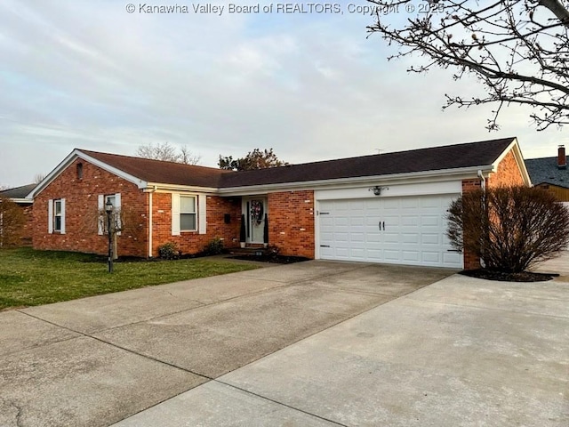 single story home featuring a front lawn, brick siding, a garage, and driveway