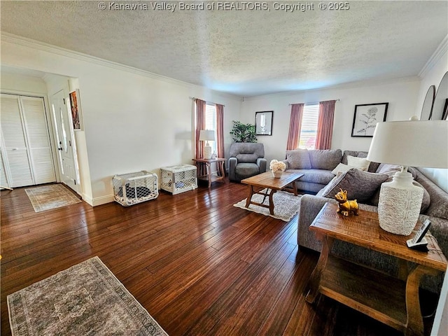 living area with ornamental molding, a textured ceiling, baseboards, and hardwood / wood-style floors