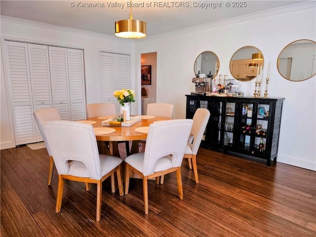 dining space featuring wood finished floors, baseboards, and ornamental molding