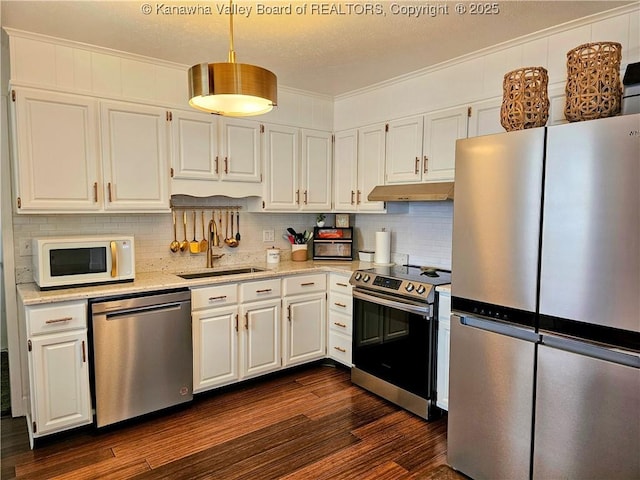 kitchen featuring white cabinets, appliances with stainless steel finishes, and a sink