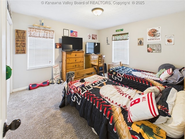 bedroom featuring carpet flooring and baseboards