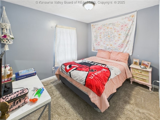 carpeted bedroom featuring baseboards