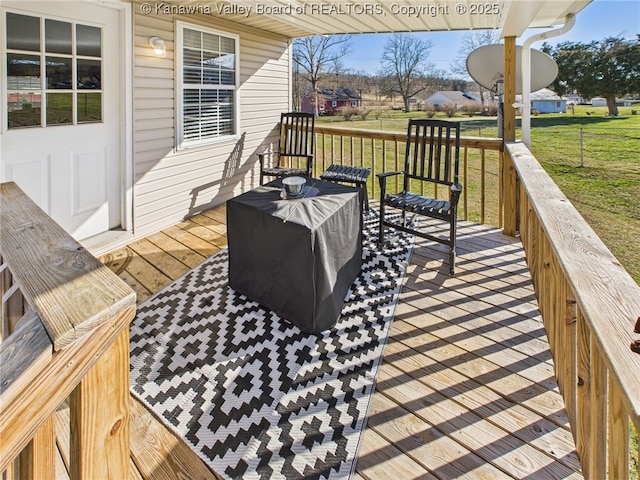 wooden deck with a lawn