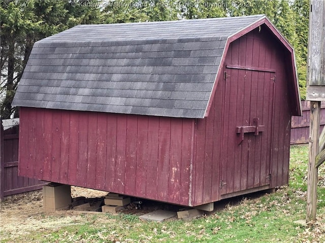 view of shed featuring fence