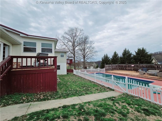 view of pool featuring a fenced in pool, a wooden deck, a yard, and fence