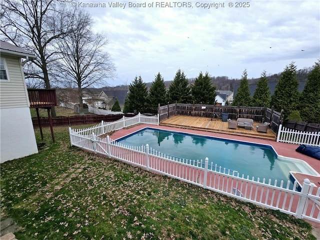 view of pool with a yard, a fenced in pool, a wooden deck, and a fenced backyard