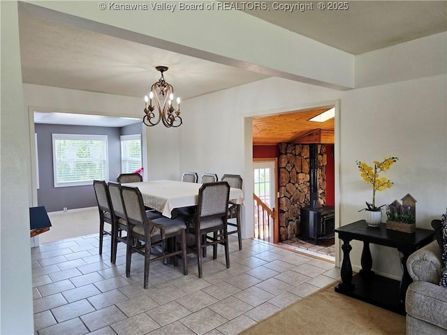 2018 Mount Vernon Rd, Hurricane, WV 25526 - dining space with a wood stove, a chandelier, and light tile patterned floors