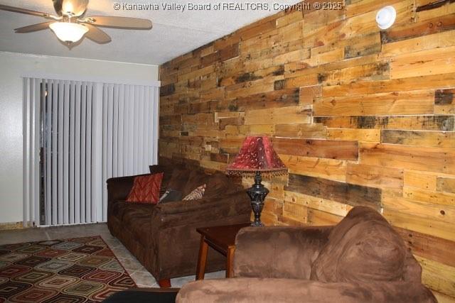 2106 Kanawha Blvd E Unit 601, Charleston, WV 25311 - living room featuring ceiling fan and wood walls