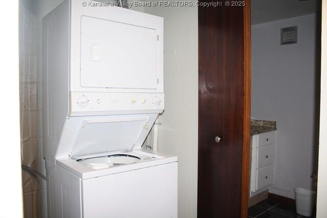 2106 Kanawha Blvd E Unit 601, Charleston, WV 25311 - clothes washing area with laundry area, dark tile patterned floors, visible vents, and stacked washing maching and dryer