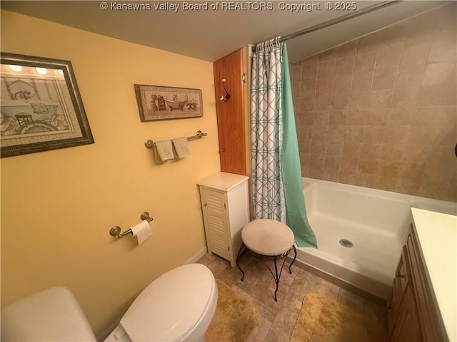 bathroom featuring toilet, a shower with curtain, and vanity