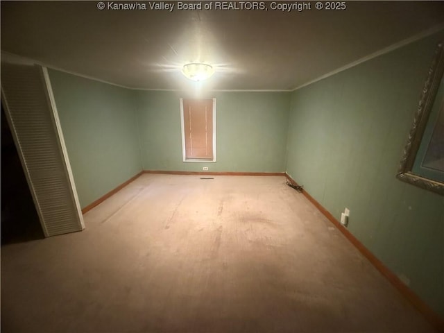 unfurnished bedroom featuring ornamental molding, baseboards, and light carpet