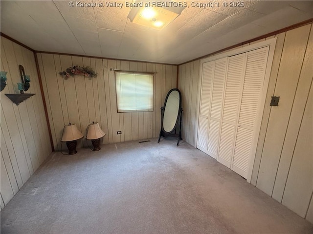 unfurnished bedroom featuring light colored carpet