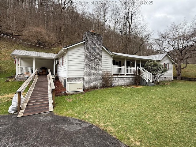 view of front of property featuring a porch, stairs, a front yard, a chimney, and crawl space