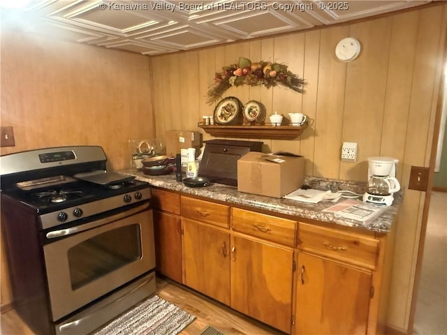 kitchen featuring gas range and brown cabinetry