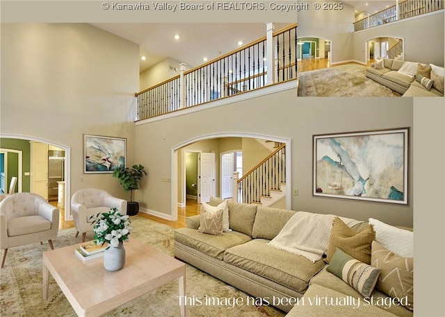 111 Graff Ln, Charleston, WV 25304 - living room featuring arched walkways, stairs, a high ceiling, recessed lighting, and baseboards