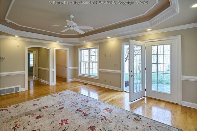 111 Graff Ln, Charleston, WV 25304 - doorway to outside featuring a tray ceiling, crown molding, ceiling fan, arched walkways, and wood finished floors