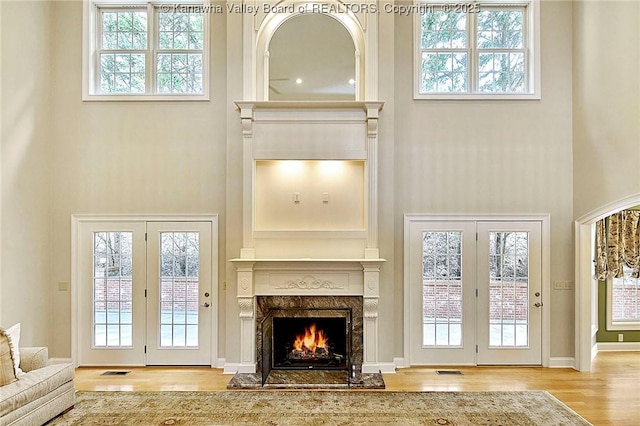 111 Graff Ln, Charleston, WV 25304 - living area with a towering ceiling, wood finished floors, a high end fireplace, and healthy amount of natural light