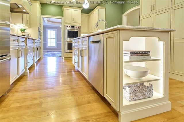 111 Graff Ln, Charleston, WV 25304 - kitchen featuring light wood-style floors, stainless steel appliances, wall chimney range hood, and light countertops