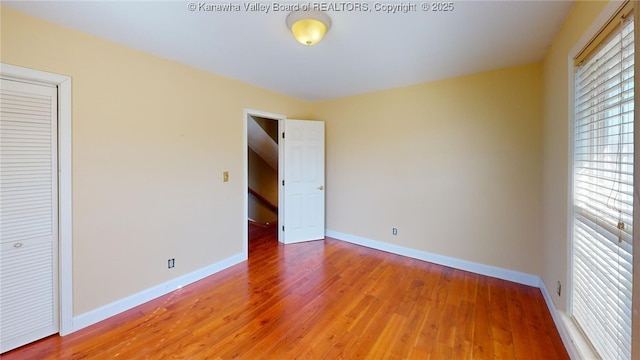 1737 US Route 60 W, Milton, WV 25541 - unfurnished bedroom with baseboards and light wood-style floors