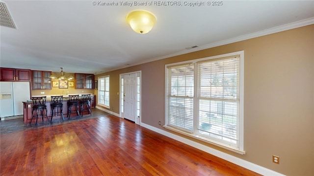 1737 US Route 60 W, Milton, WV 25541 - kitchen with a breakfast bar area, dark wood-style floors, visible vents, glass insert cabinets, and white fridge with ice dispenser