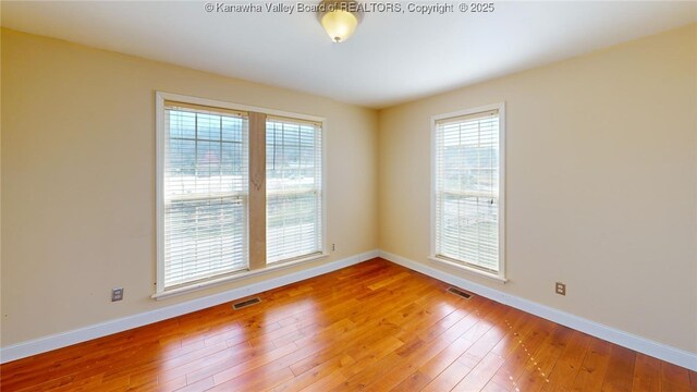 1737 US Route 60 W, Milton, WV 25541 - empty room featuring visible vents, baseboards, and hardwood / wood-style flooring