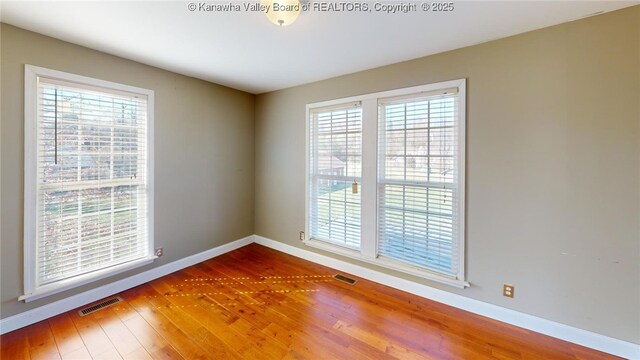1737 US Route 60 W, Milton, WV 25541 - empty room featuring visible vents, baseboards, and wood finished floors