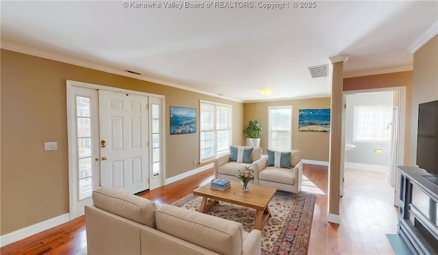 1737 US Route 60 W, Milton, WV 25541 - living room with light wood-type flooring, visible vents, baseboards, and crown molding