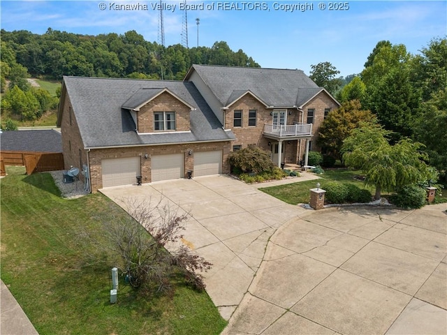 75 Poinsettia Dr, Scott Depot, WV 25560 - traditional home with concrete driveway, a balcony, a garage, and a front yard