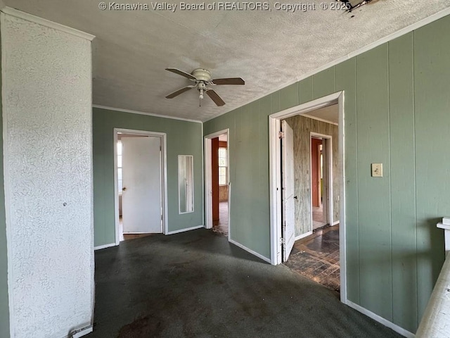 2509 Adams Ave, Huntington, WV 25704 - unfurnished room with ceiling fan, baseboards, wooden walls, and ornamental molding