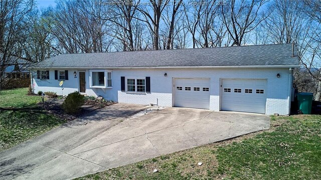 ranch-style house with concrete driveway, a garage, brick siding, and a front lawn