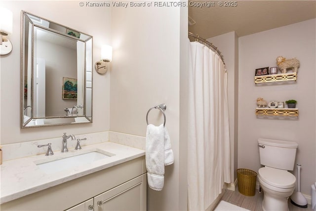 bathroom with vanity, a shower with shower curtain, and toilet