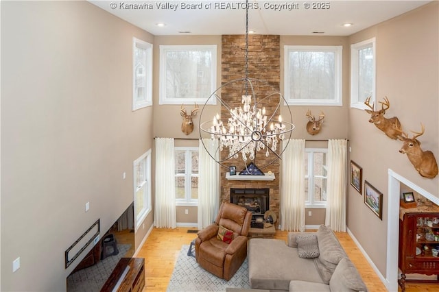 living area featuring light wood-style flooring, a healthy amount of sunlight, and a fireplace
