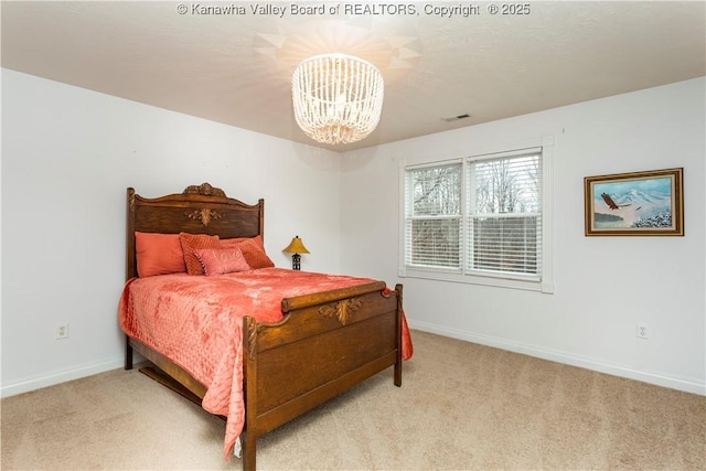 carpeted bedroom with baseboards, visible vents, and a notable chandelier