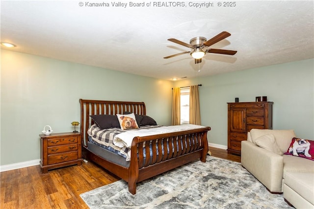 bedroom featuring baseboards, a ceiling fan, and wood finished floors