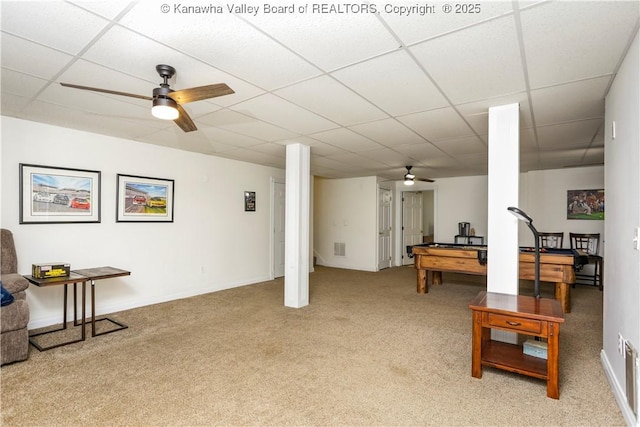 game room with a ceiling fan, light colored carpet, and a paneled ceiling