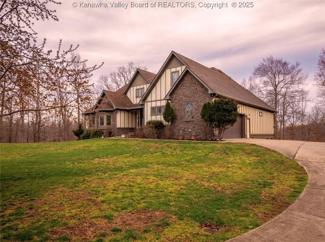 356 Latigo Pt, Milton, WV 25541 - tudor house featuring board and batten siding, driveway, a front lawn, and a garage