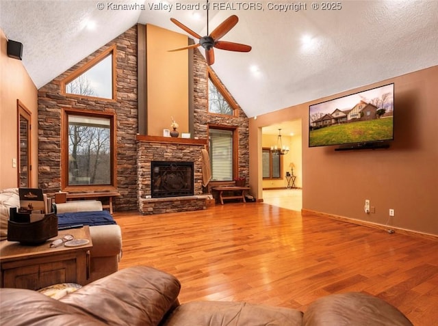 356 Latigo Pt, Milton, WV 25541 - living area featuring ceiling fan, a fireplace, wood finished floors, a chandelier, and a textured ceiling