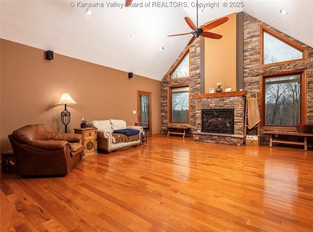 356 Latigo Pt, Milton, WV 25541 - living room featuring a stone fireplace, wood finished floors, high vaulted ceiling, and a ceiling fan